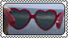 heart shaped sunglasses at the ocean